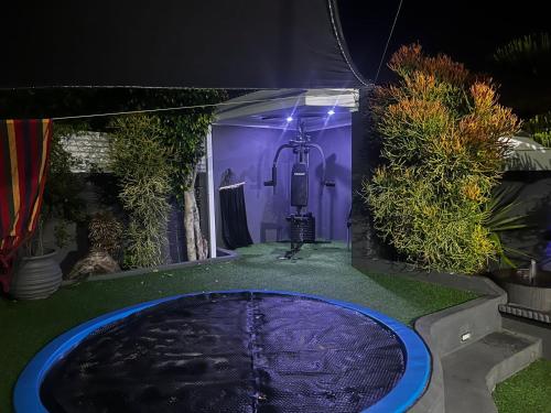 a large pool of water in a backyard at night at Mitchell's Guesthouse in Parow