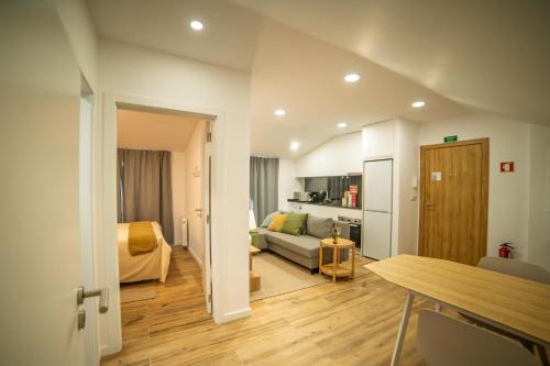 a living room with a couch and a bed at Charming Santo Antonio Roof top in Monção