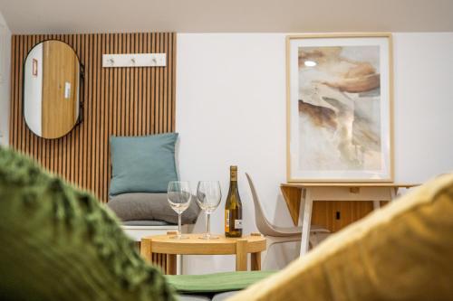 a living room with wine glasses and a couch at Charming Santo Antonio Roof top in Monção