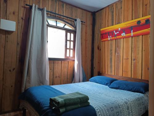 a bedroom with a bed and a window at Brisa da Mata Ecolodges in Morretes