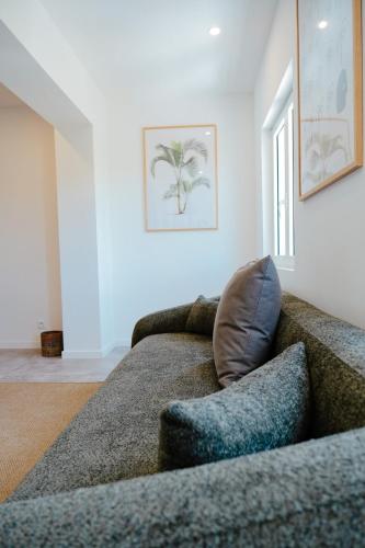 a living room with a couch with a pillow at Suite 7 Mogador Residence, 1BR, brand-new, rare & luxury, beachfront in Grand Case