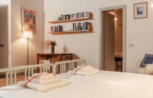 a bedroom with a bed with two white towels at Lake Varese villa in Azzate