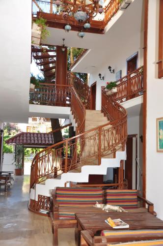 a staircase in a building with a bench and a table at Kaliptus Hotel in Kemer