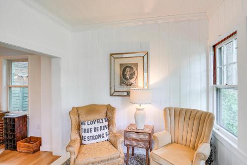 a living room with a chair and a lamp at Steps to Downtown Stockbridge Home with Patio! in Stockbridge