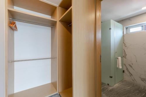 a walk in closet with a sliding glass door at Exclusive apartment- Rooftop pool in Cancún
