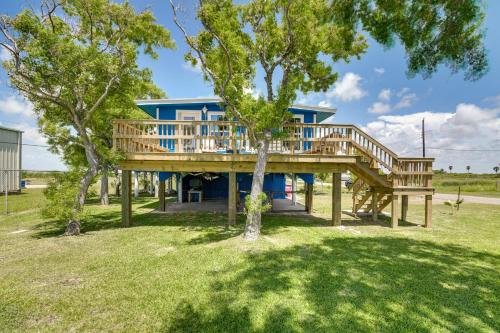 a home with a large deck with trees in the yard at 2 Mi to Public Beach Pet-Friendly Freeport Home! in Freeport