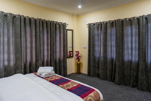 a bedroom with black curtains and a bed in a room at The Khayabaan - Your Fully Equipped Air-Conditioned Serviced Apartments in Srinagar in Srinagar