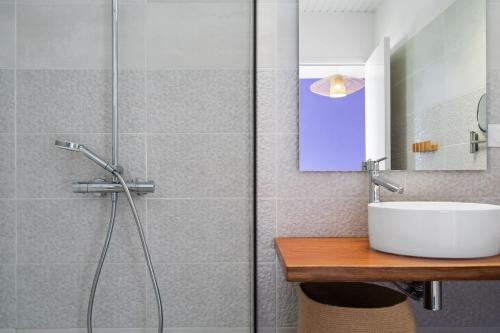 a bathroom with a shower and a white sink at Villa Keyana in Ducos