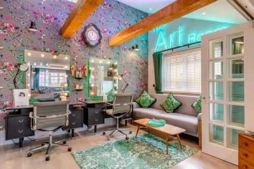 a salon with a purple wall with flowers at Karmacations in Alton Pancras