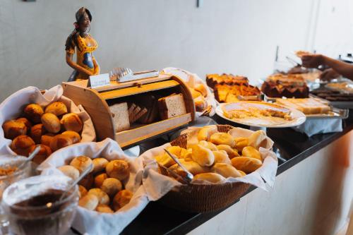 a buffet of bread and pastries on a table at Sol Victoria Marina in Salvador