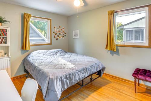 a bedroom with a bed and two windows at Walk to Spring Lake with Waterpark Family Retreat! in North Mankato