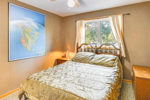 a bedroom with a bed and a map on the wall at Walk to Spring Lake with Waterpark Family Retreat! in North Mankato