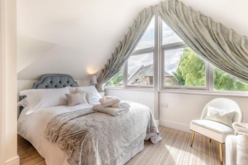 a bedroom with a bed and a large window at Riverside Cottage - Wareham in Wareham