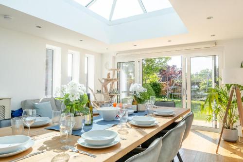 a dining room with a long wooden table and chairs at No. 41 - Sandown in Sandown