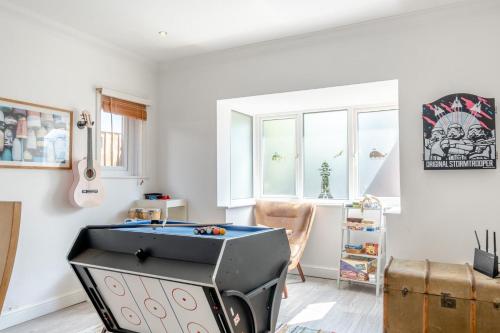 a room with a ping pong table in the corner at No. 41 - Sandown in Sandown