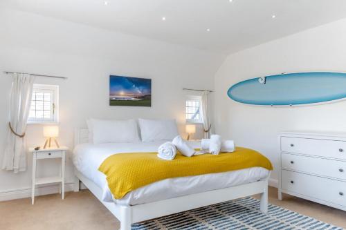 a bedroom with a bed with a surfboard on the wall at No. 41 - Sandown in Sandown
