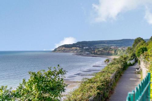 a beach with a fence next to the ocean at No. 41 - Sandown in Sandown