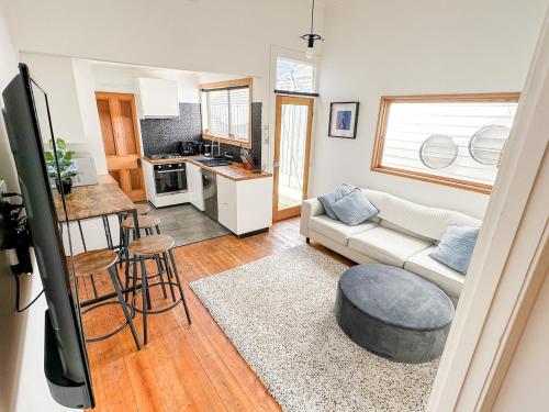 a living room with a couch and a table at Cosy Home In Middle Park, Near Beach and City with Sauna in Melbourne
