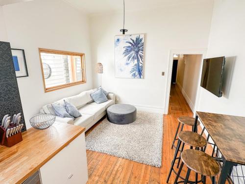 a living room with a couch and a table at Cosy Home In Middle Park, Near Beach and City with Sauna in Melbourne