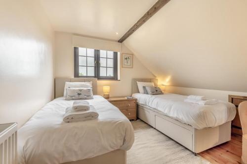 a bedroom with two beds and a window at Abbeydale in Wool