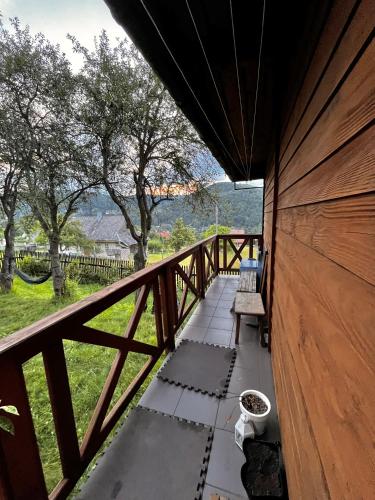 a balcony with a bench and a view of a field at Dom Ponad Wsią in Zawoja