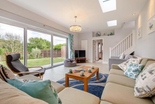 a living room with a couch and a table at Homelands in Studland