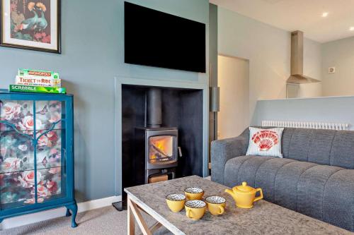 a living room with a couch and a fire place at Beech View 4 in Corsley