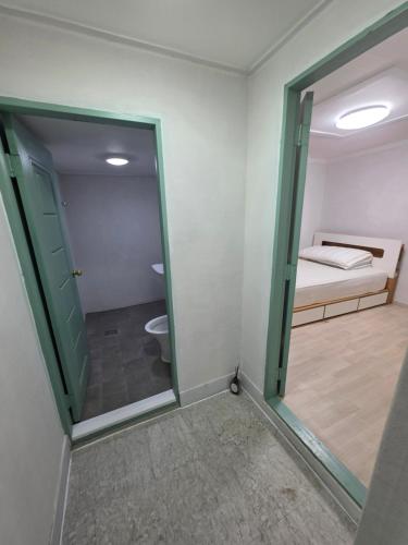a room with a door leading to a bedroom with a bed at 경주펜션 Gyeongju Pension in Incheon