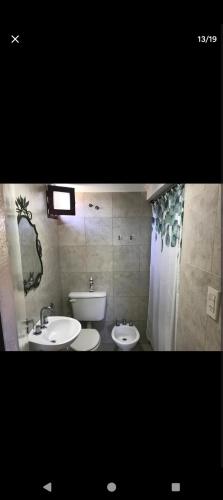 a bathroom with two sinks and a shower at Santa fe Boulevard apartment with AC and Wifi in Vuelta del Paraguayo