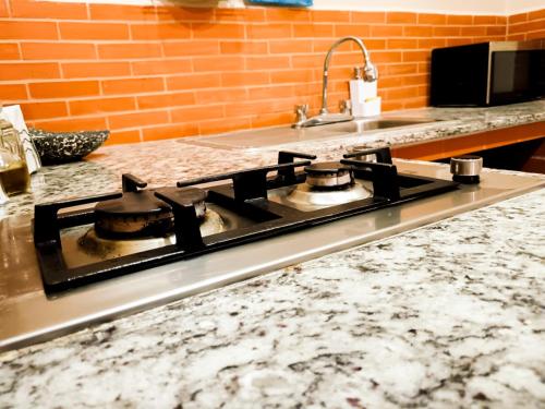 a kitchen counter with a stove top in a kitchen at Stay6 Confort en Grupo Durango in Durango