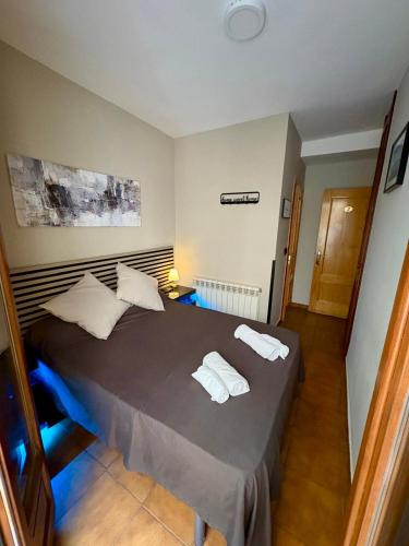 a bedroom with a bed with two towels on it at Pensión San Pedro in Viana