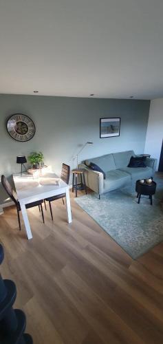 a living room with a couch and a table at Costa C en E in Noordwijk