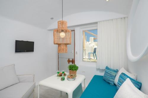 a living room with a couch and a table at Orkos Beach Hotel in Mikri Vigla