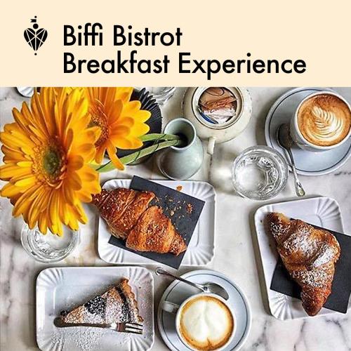 a table with plates of food and a cup of coffee at Biffi 2 - Garbatella Rooms in Rome