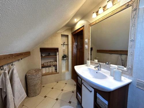 a bathroom with a sink and a mirror at Słupiecki Zakątek in Nowa Ruda