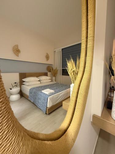 a bedroom with a bed and a hammock at Sensi resort Nikiti in Nikiti