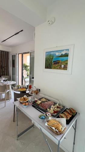 a table with many different types of food on it at Cefalù Luxury Suite in Cefalù