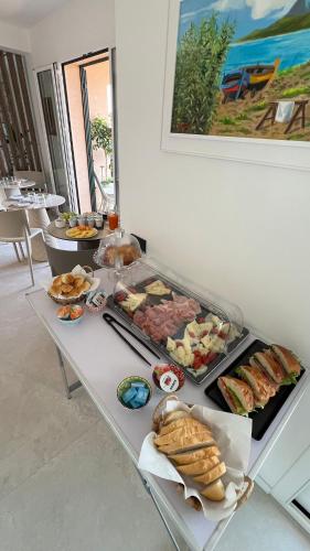 a table with many different types of food on it at Cefalù Luxury Suite in Cefalù