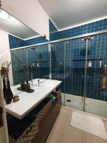 a bathroom with a sink and a shower with blue tiles at BEST OF NATURE 1, Matosinhos beach, Porto city parc, METRO in Matosinhos