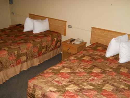 a hotel room with two beds in a room at TC Motel in Medicine Hat