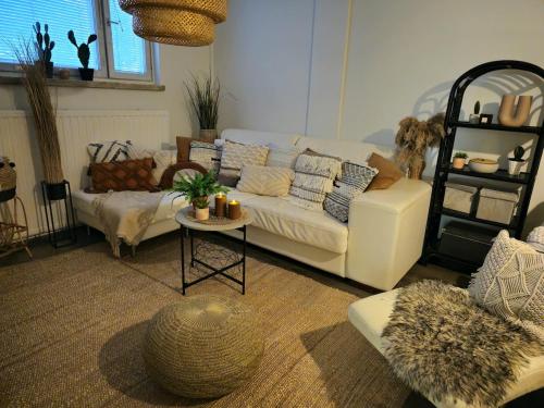 a living room with a white couch and a table at 3room apartment at central Jyväskylä in Jyväskylä