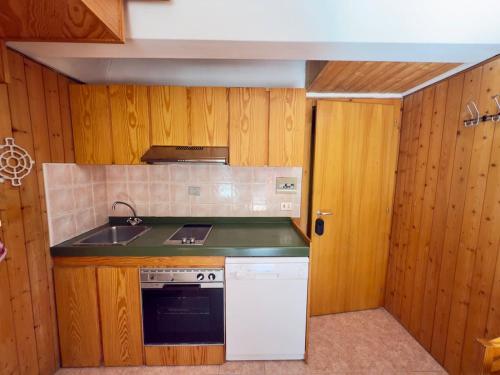a small kitchen with a stove and a sink at Sole Alto Charm, Parking & Wi-Fi in Marilleva