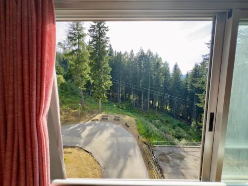 a window with a view of a road through it at Sole Alto Charm, Parking & Wi-Fi in Marilleva