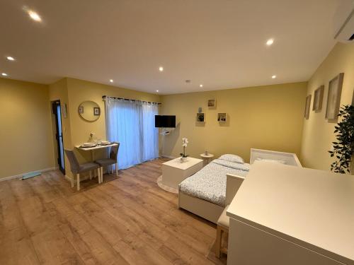 a bedroom with a bed and a desk and a sink at TinyMoko - Mons - proche du Shape et Pairi Daiza in Mons