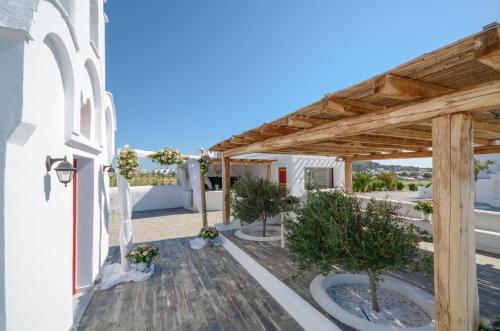a view of the patio of a house with a wooden pergola at Orkos Beach Hotel in Mikri Vigla