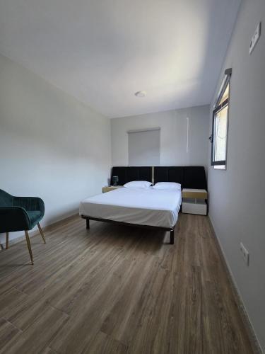 a bedroom with a bed and a wooden floor at Douro Valley - Casa do Padrinho in Escamarão