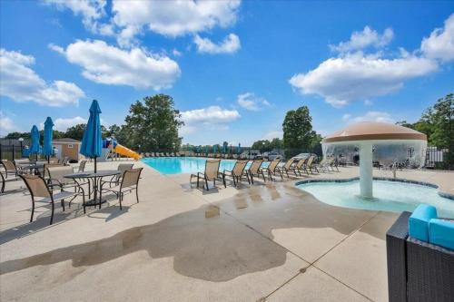 a pool with chairs and tables and umbrellas at The Pointe - Serenity Shores - 3204 in Huddleston