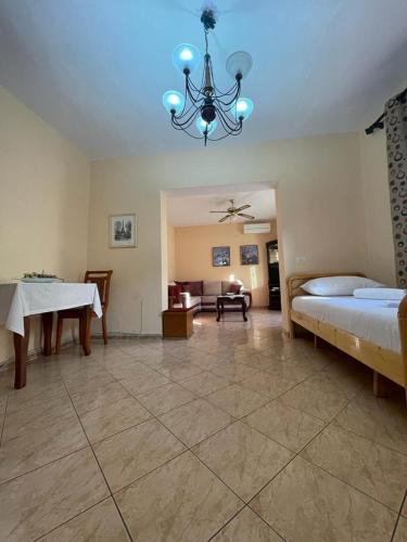 a large room with two beds and a chandelier at NEO Apartments in Tirana