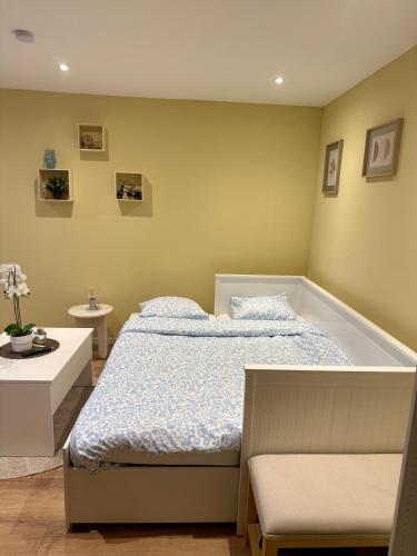 a bedroom with a bed and a bath tub at TinyMoko - Mons - proche du Shape et Pairi Daiza in Mons