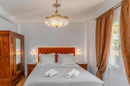 a bedroom with a bed with two towels on it at Athens Plaka Acropolis Suites in Athens